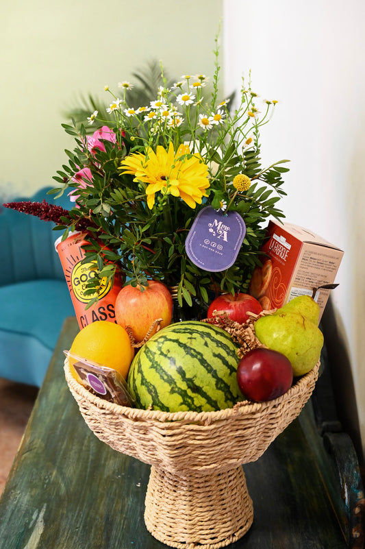 Basket of fruits, flowers and delicacies